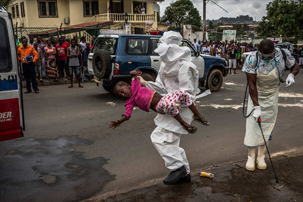 17. Aug. 31, 2014.  Esther Doryen, 5 years old, is carried to an ambulance in Monrovia. She died a week later.
