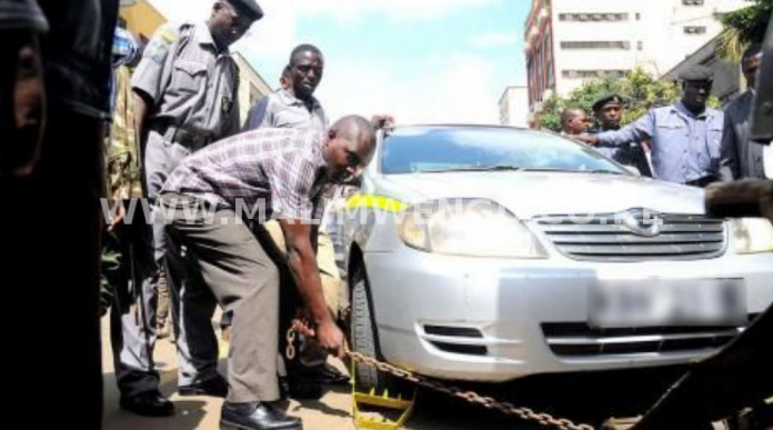 County officers clamping a car